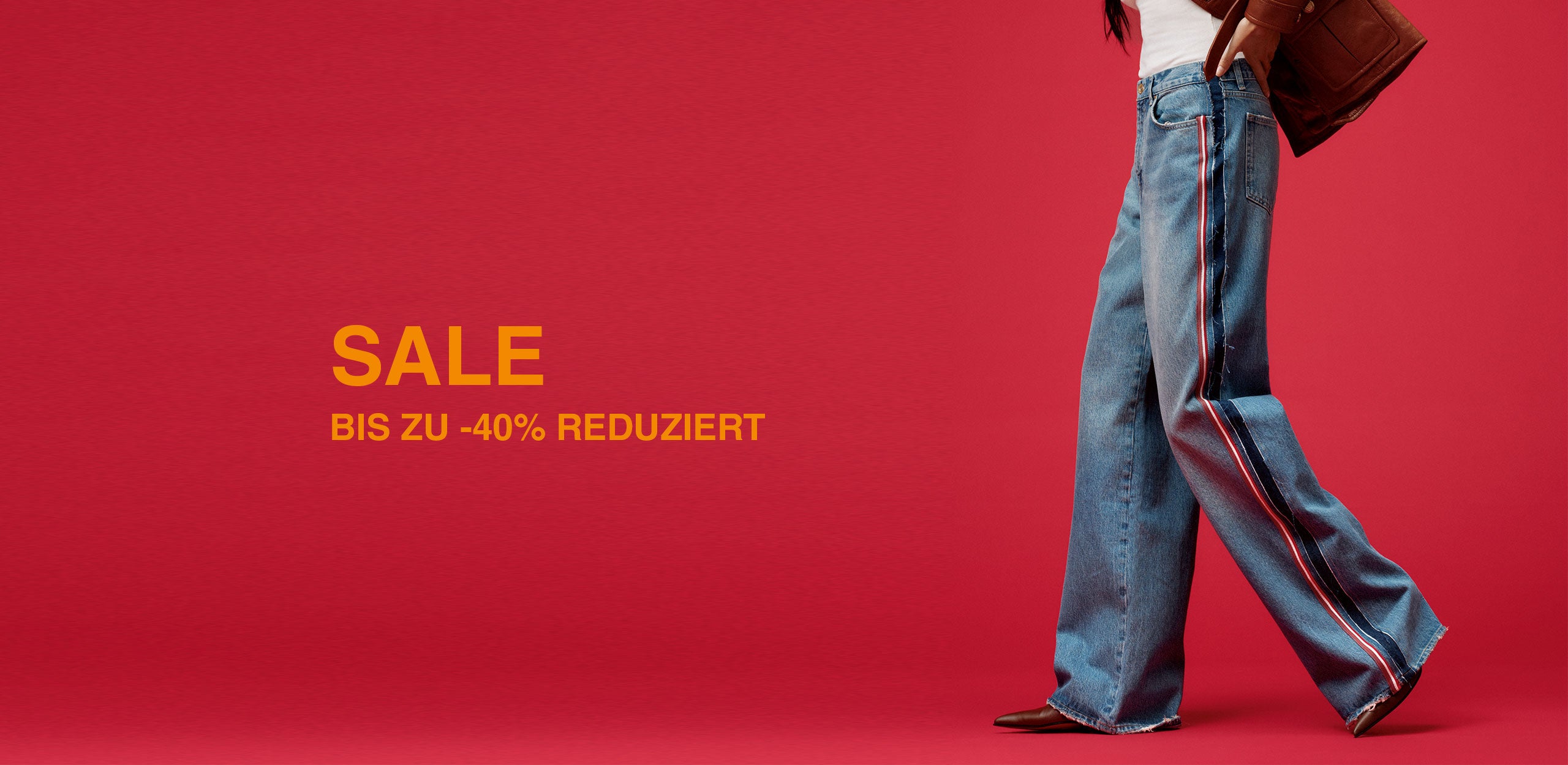 Model wearing wide-leg blue jeans with side stripe, shown in profile against a red background with SALE text up to 40% off.