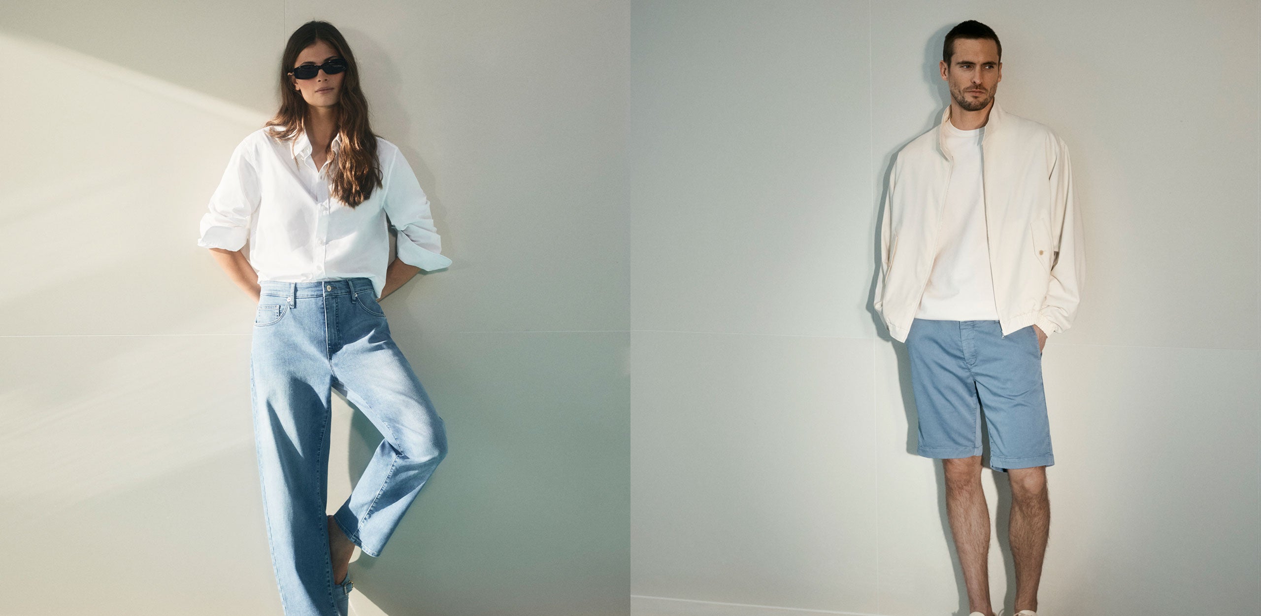 Minimal summer fashion campaign featuring a woman in a white shirt and light blue wide-leg jeans alongside a man in a light jacket and blue shorts. Clean neutral background, soft sunlight and modern casual styling create a relaxed warm-weather mood.