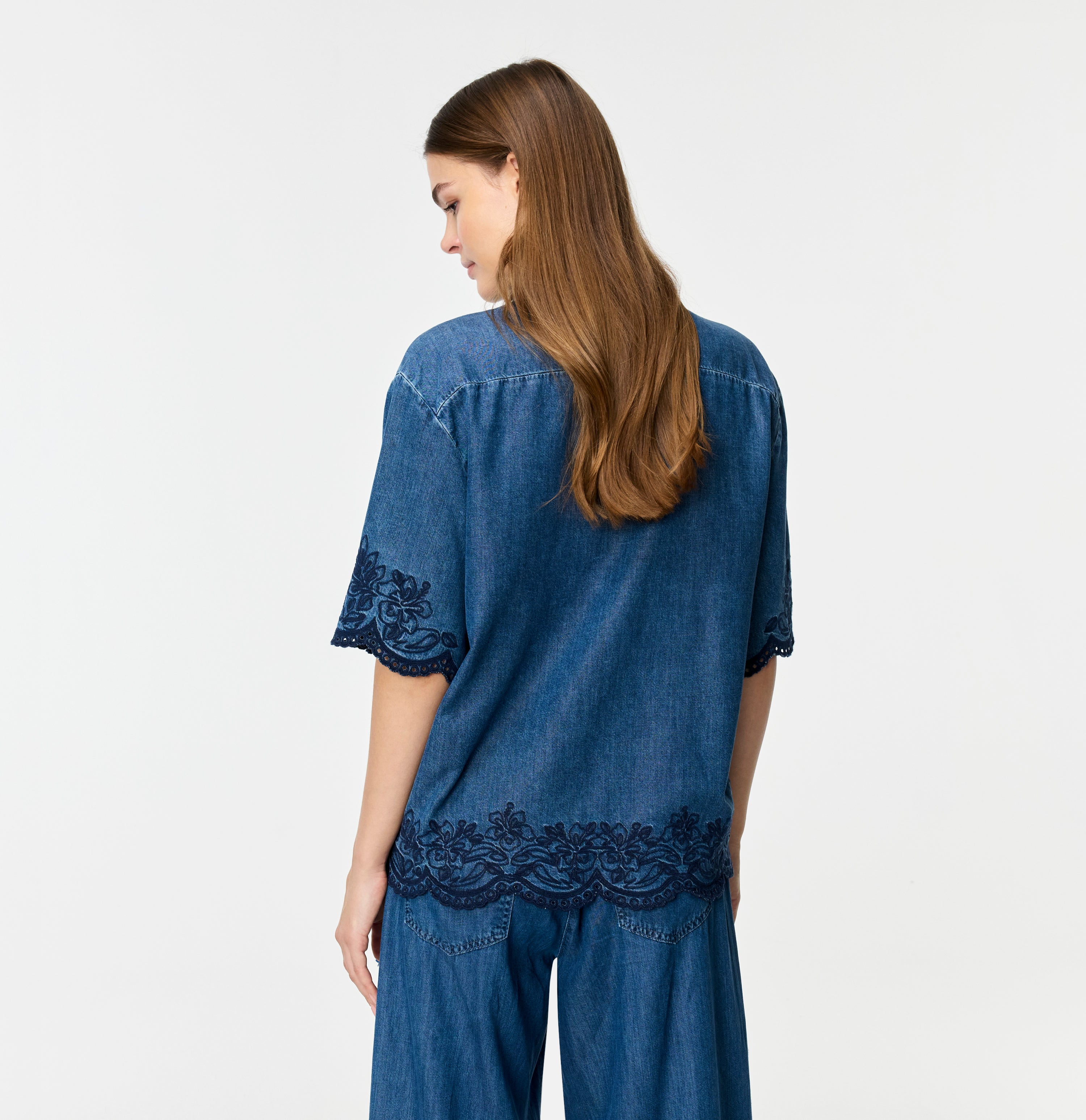 Light denim shirt with embroideries. | SHIRT embro | mid blue heritage wash | Back view of model