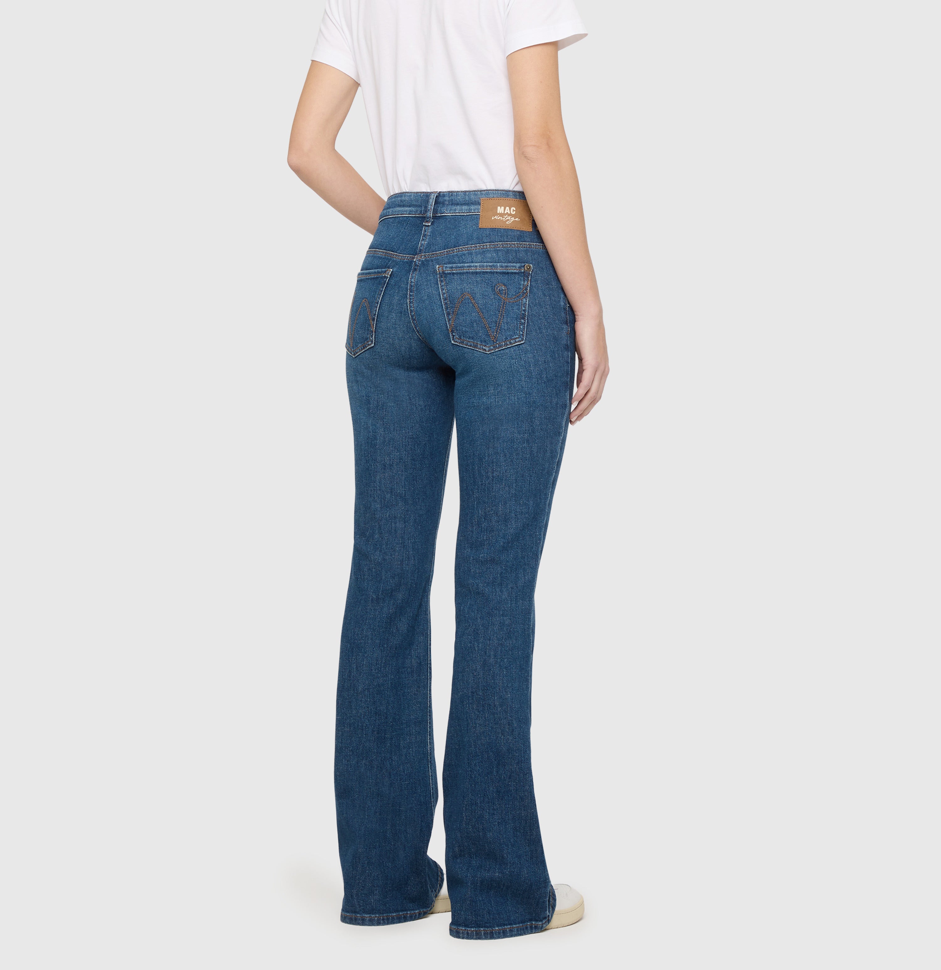 Flared jeans with modern details. | DETROIT flared | essential mid blue | Back view of model