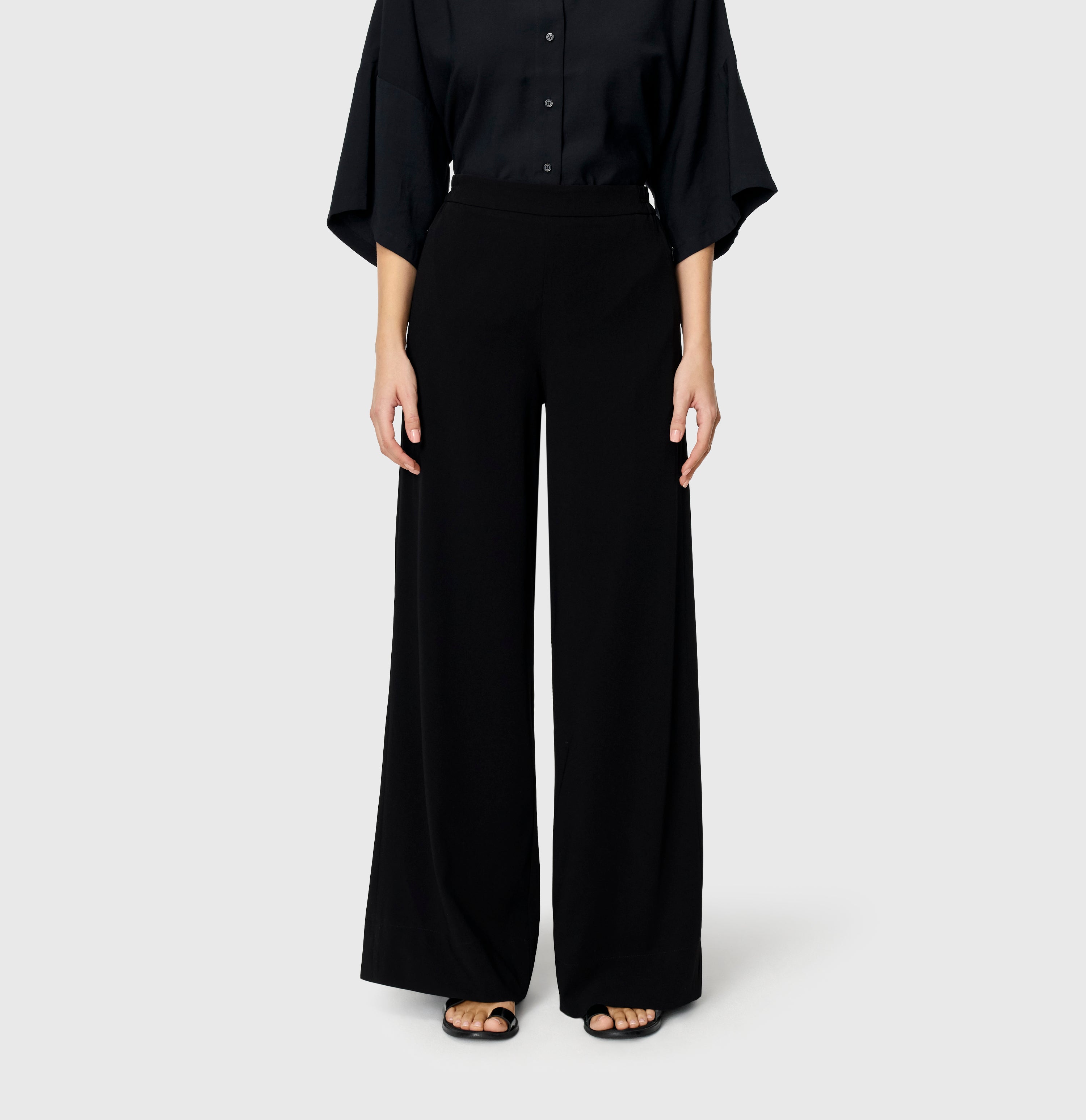 Wide fit in a flowing floating crepe material. | CORALIE | black | Front view of model