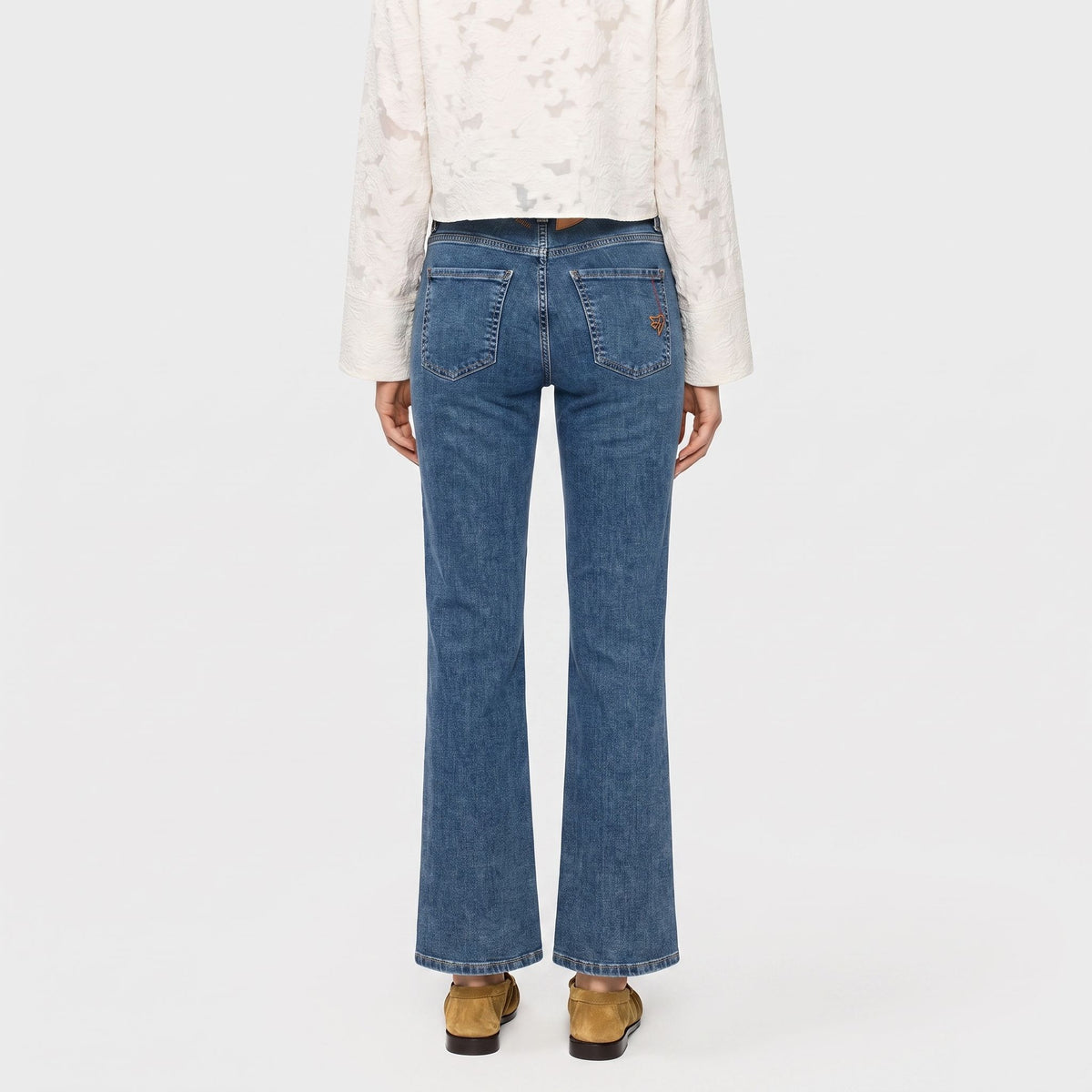 Flared jeans with modern details. | LAURA PEACE | authentic tinted wash | Back view of model