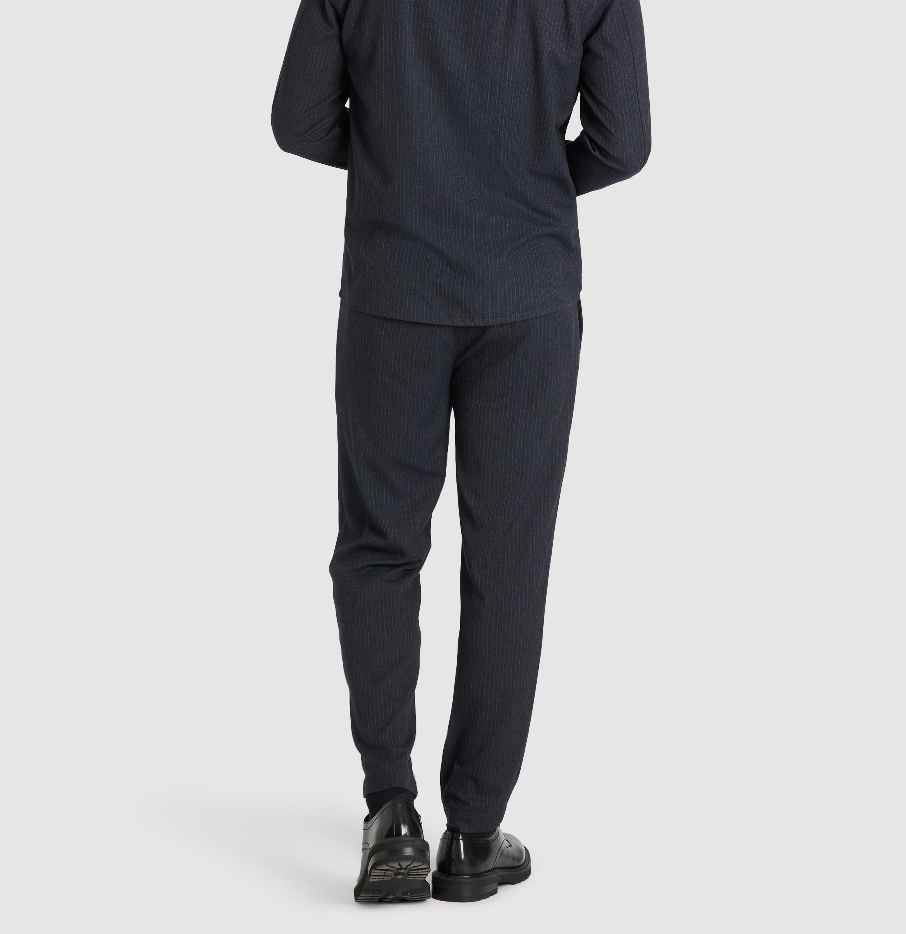 Flannel chino with fine pinstripes. | Dean | midnight blue stripes | Back view of model