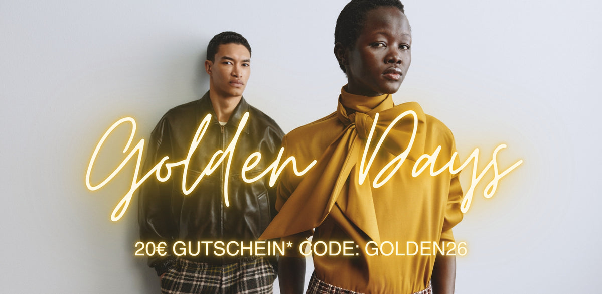 Two fashion models wearing autumn outfits in olive green and golden yellow, with glowing “Golden Days” lettering and a €20 voucher offer using code GOLDEN26.