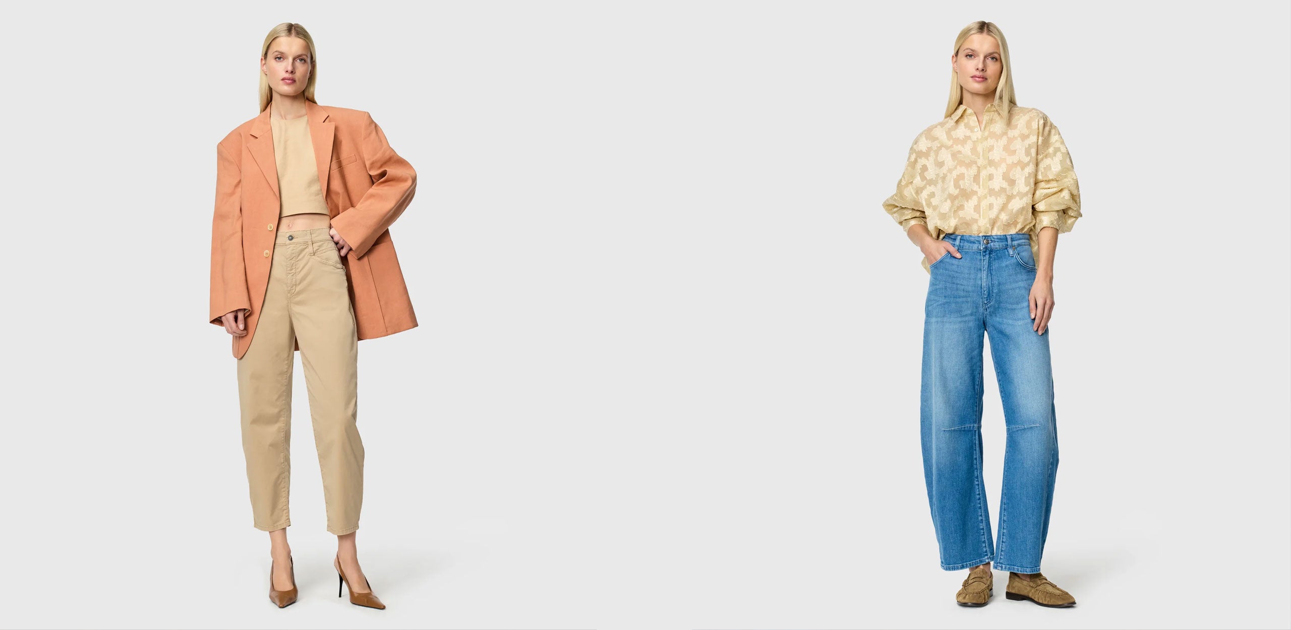 Two women standing against a neutral background in relaxed, casual looks; one in blue barrel leg jeans and a patterned blouse, the other in a peach blazer with beige trousers and heels.