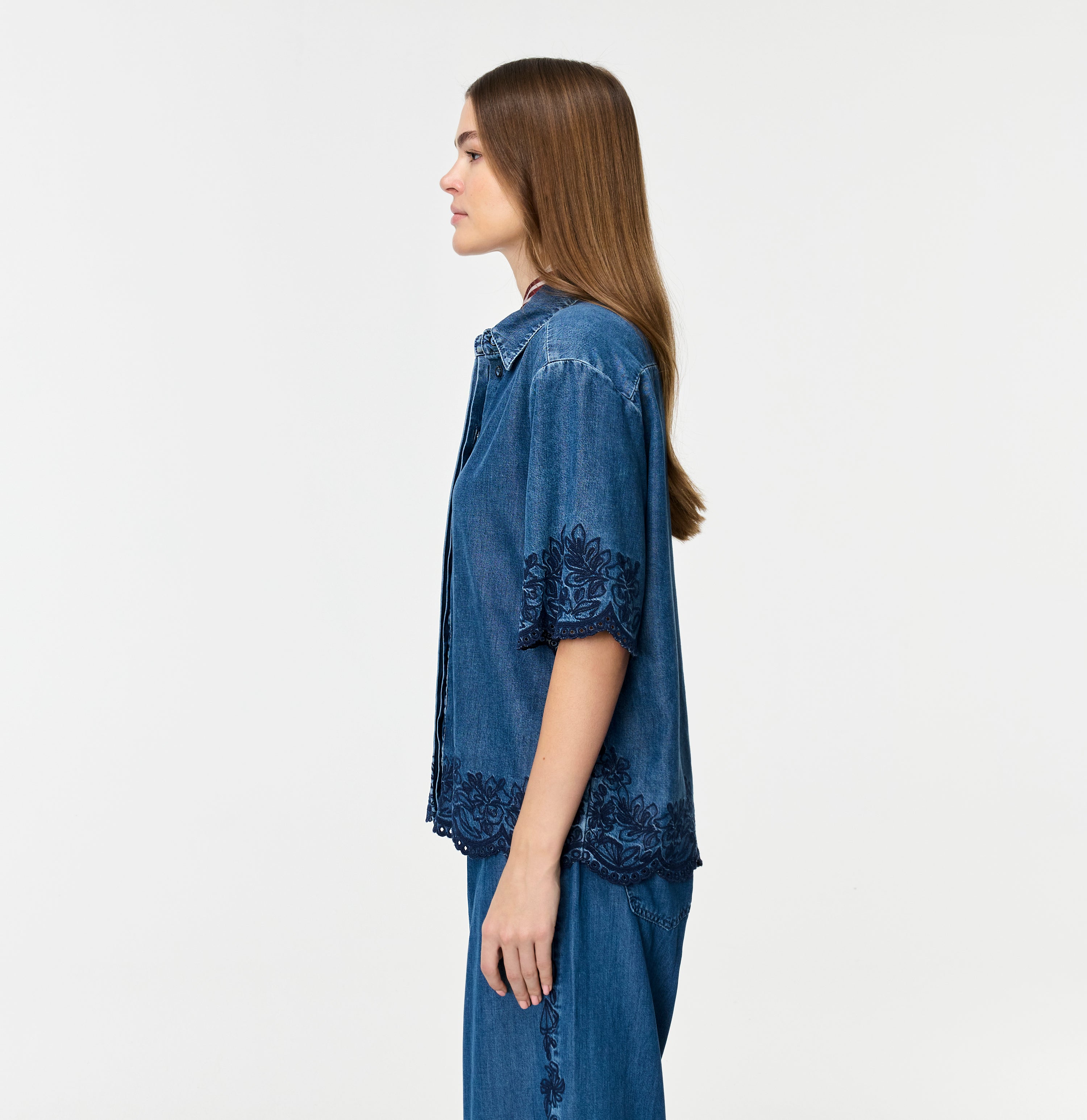 Light denim shirt with embroideries. | SHIRT embro | mid blue heritage wash | Side view of model