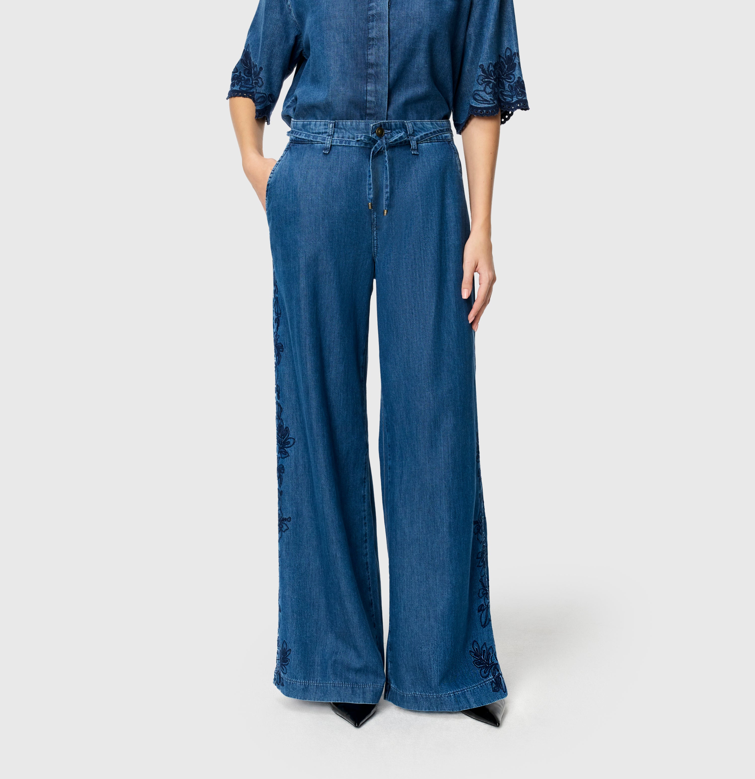 Light, wide jeans with floral embroideries. | WENDY embro | mid blue heritage wash | Front view of model