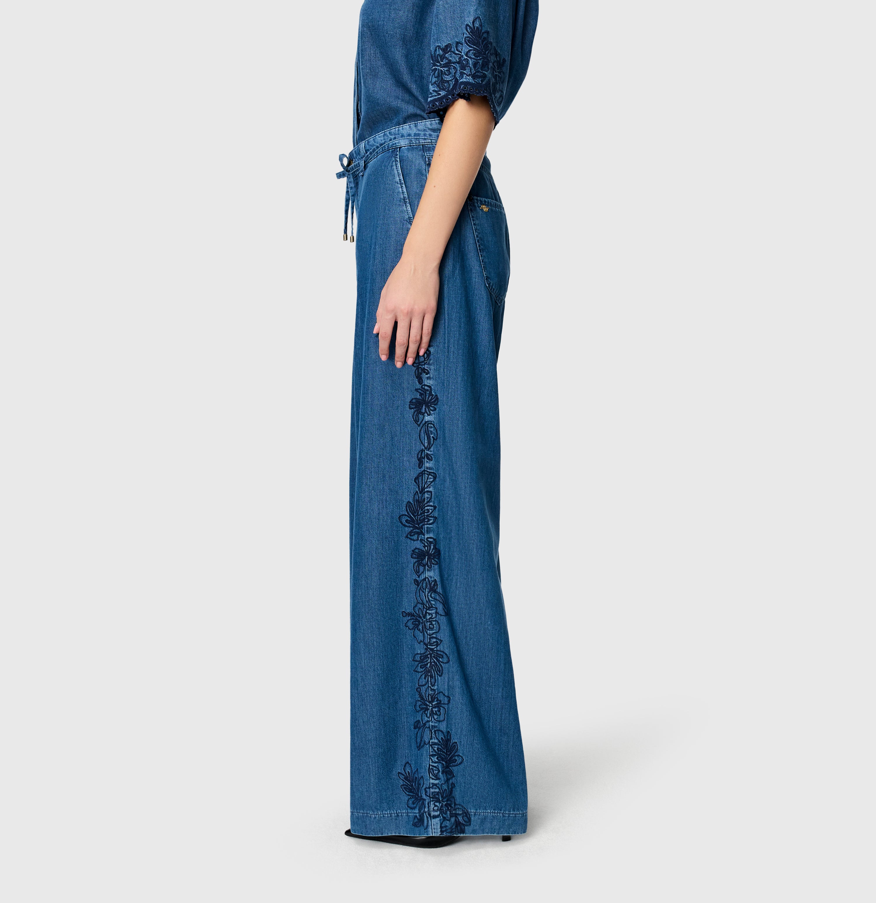 Light, wide jeans with floral embroideries. | WENDY embro | mid blue heritage wash | Side view of model