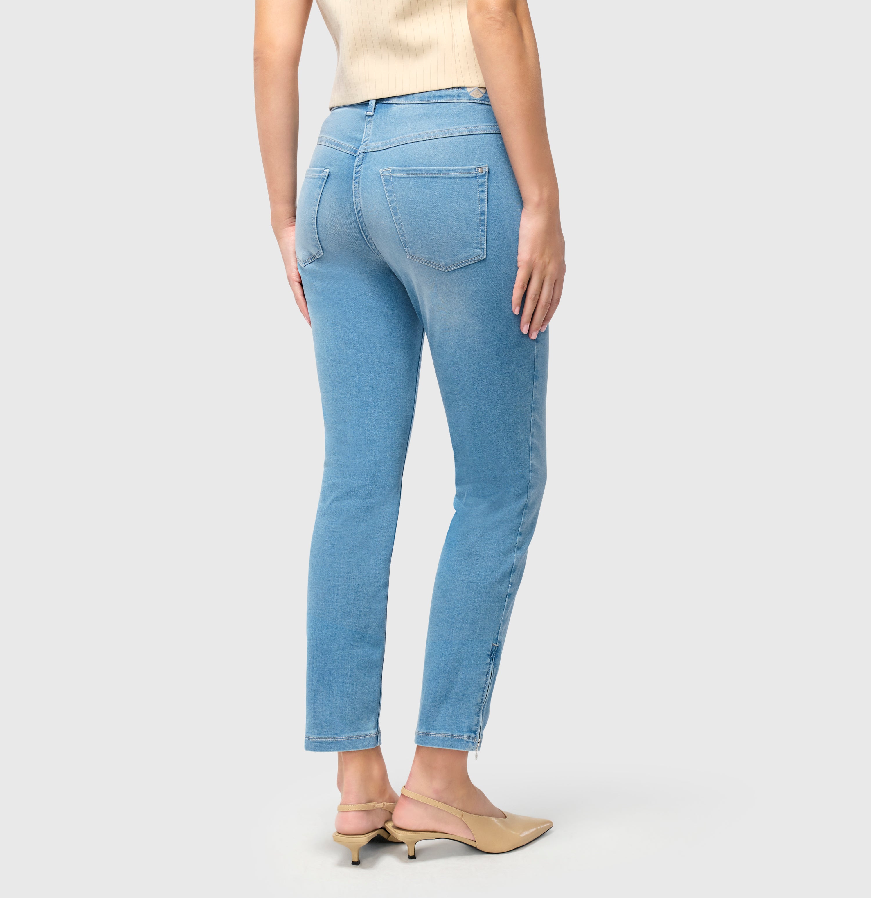 Cropped hyper stretch jeans with zip detail. | DREAM CHIC | classy grey blue wash | Back view of model