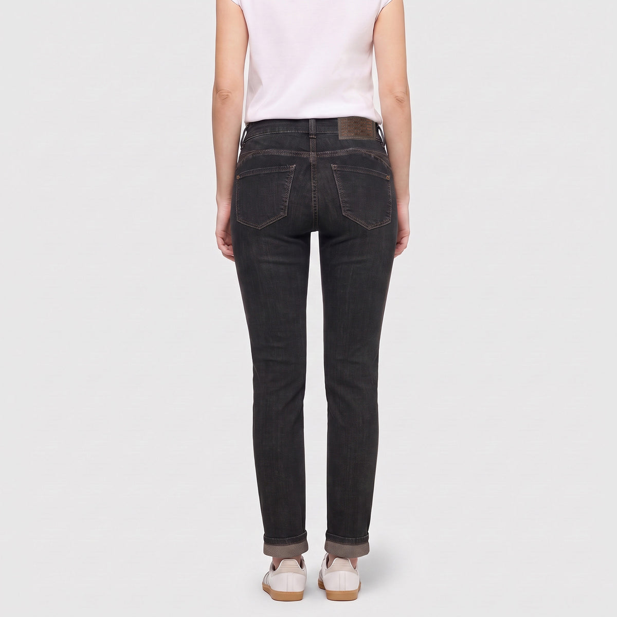 Slim jeans with pocket detail. | SLIM | brown tinted black wash | Back view of model