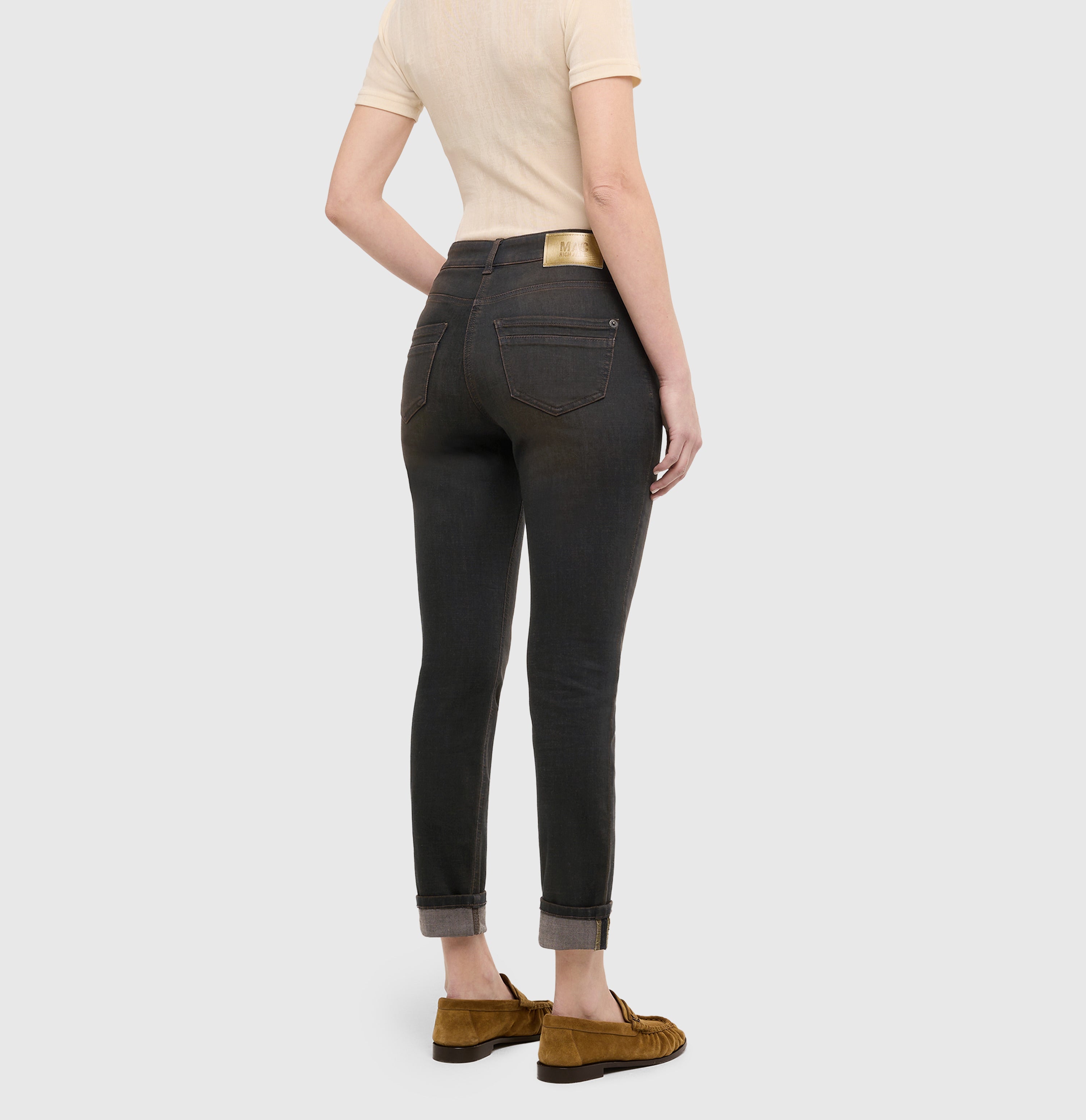 Slim jeans in a light cotton-modal blend. | RICH SLIM | soft black brown used | Back view of model