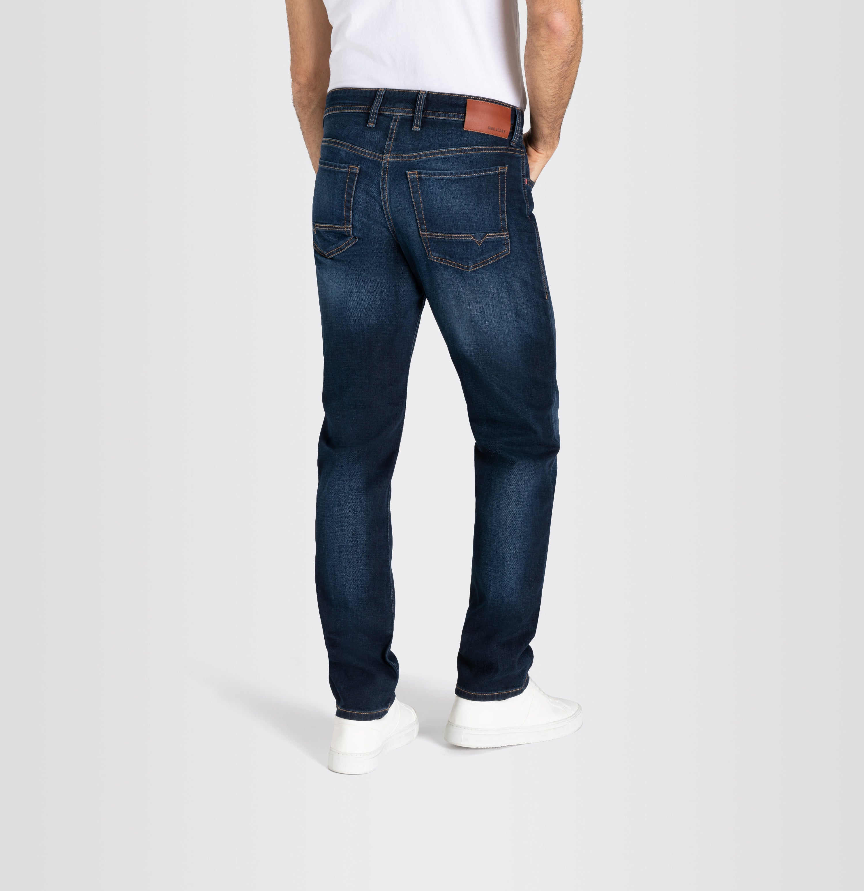Light, modern fit in a sporty, grainy wash. | Arne | dark vintage blue | Back view of model